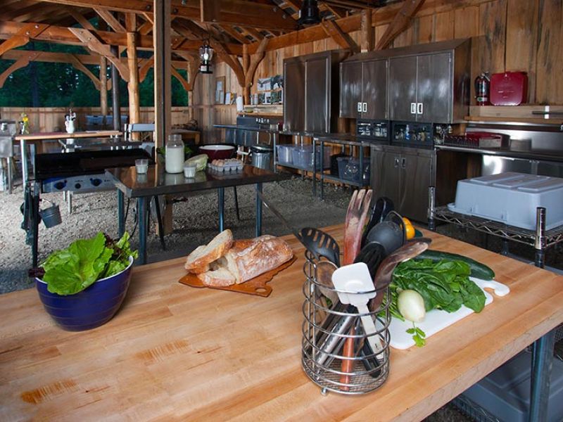 well-stocked cookhouse with farm fresh food on prep table