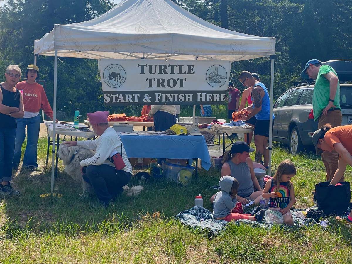 Turtle Trot annual trail race fundraising event start and finish line tent with participants