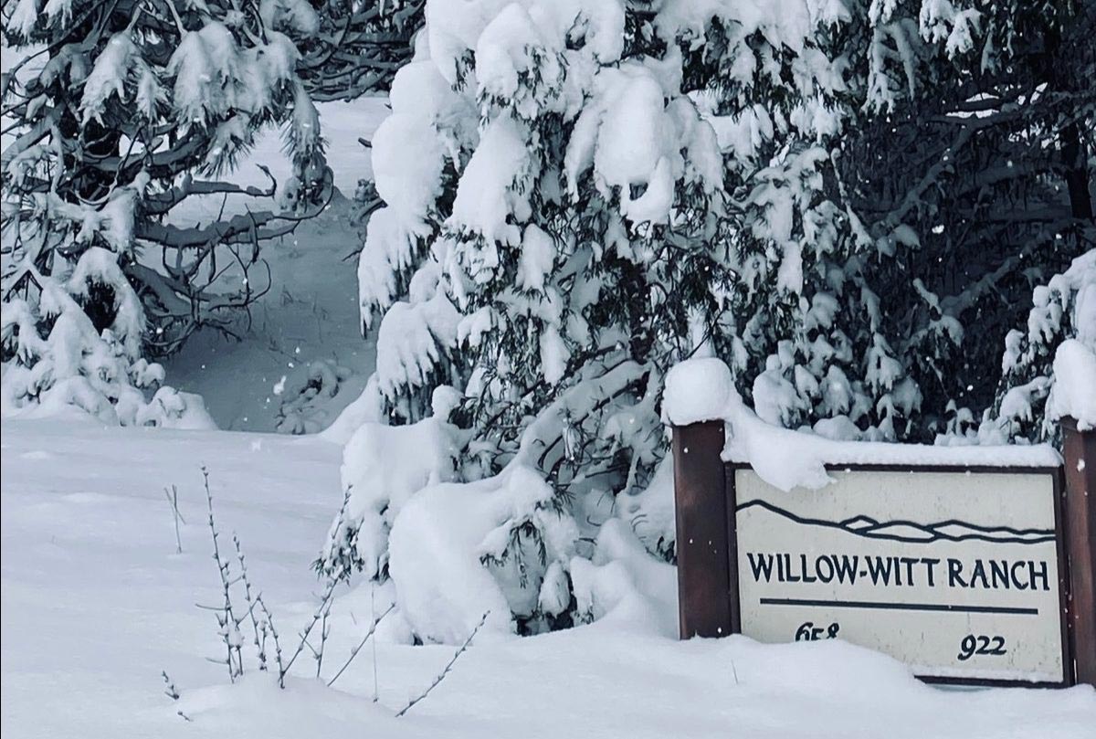 roadside sign at the entrance of Willow-Witt Ranch covered in snow