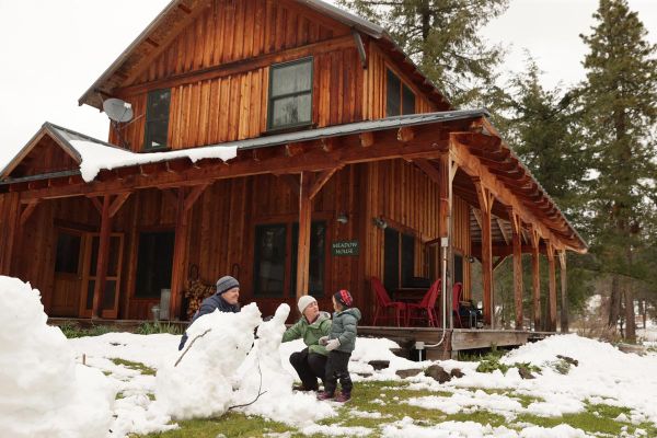 family building snowmen during winter farm stay at the Meadow House