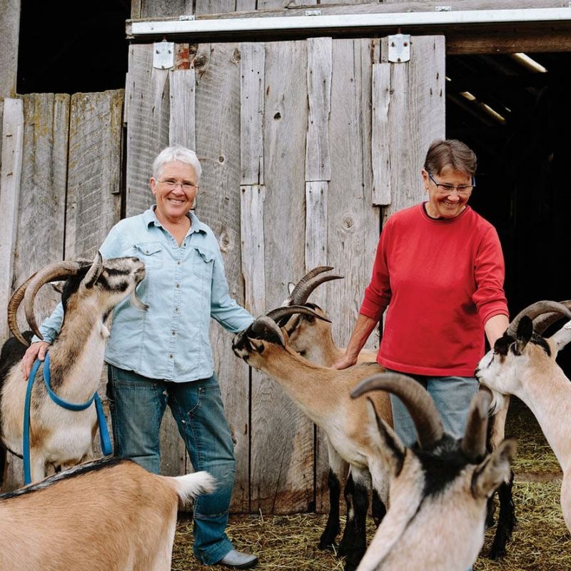 Dr. Lanita Witt and Suzanne Willow with their Alpine Goats pose for Modern Farmer magazine