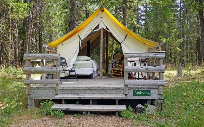 Redwing wall tent exterior with deck, table and chairs