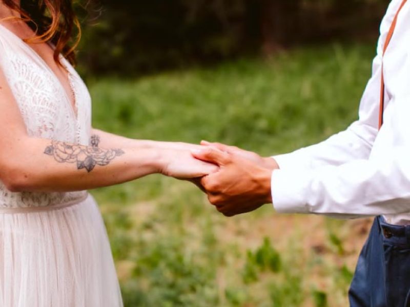 bride and groom holding hands